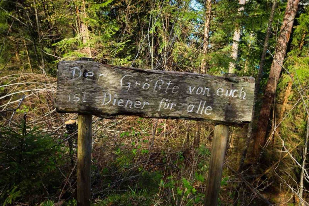 Holzschild mit inspirierendem Spruch entlang des Dien-Mut-Wegs